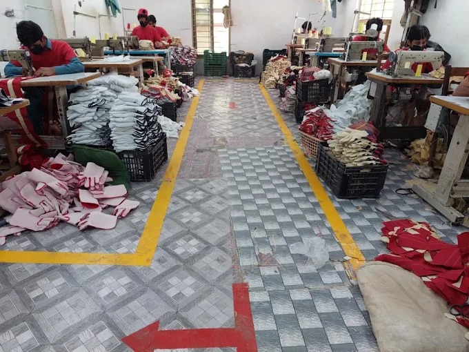 Sewing machine workstations and factory floor at the Maswiz Industries garment production facility.